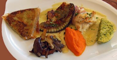 photo of sea bass filet on asparagus creme with vegetables