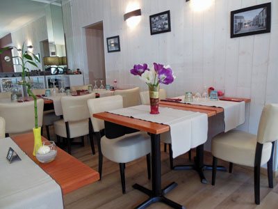 flowers on tables in corner of cozy Restaurant Genista